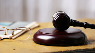 Glasses and hammer on a judges' desk